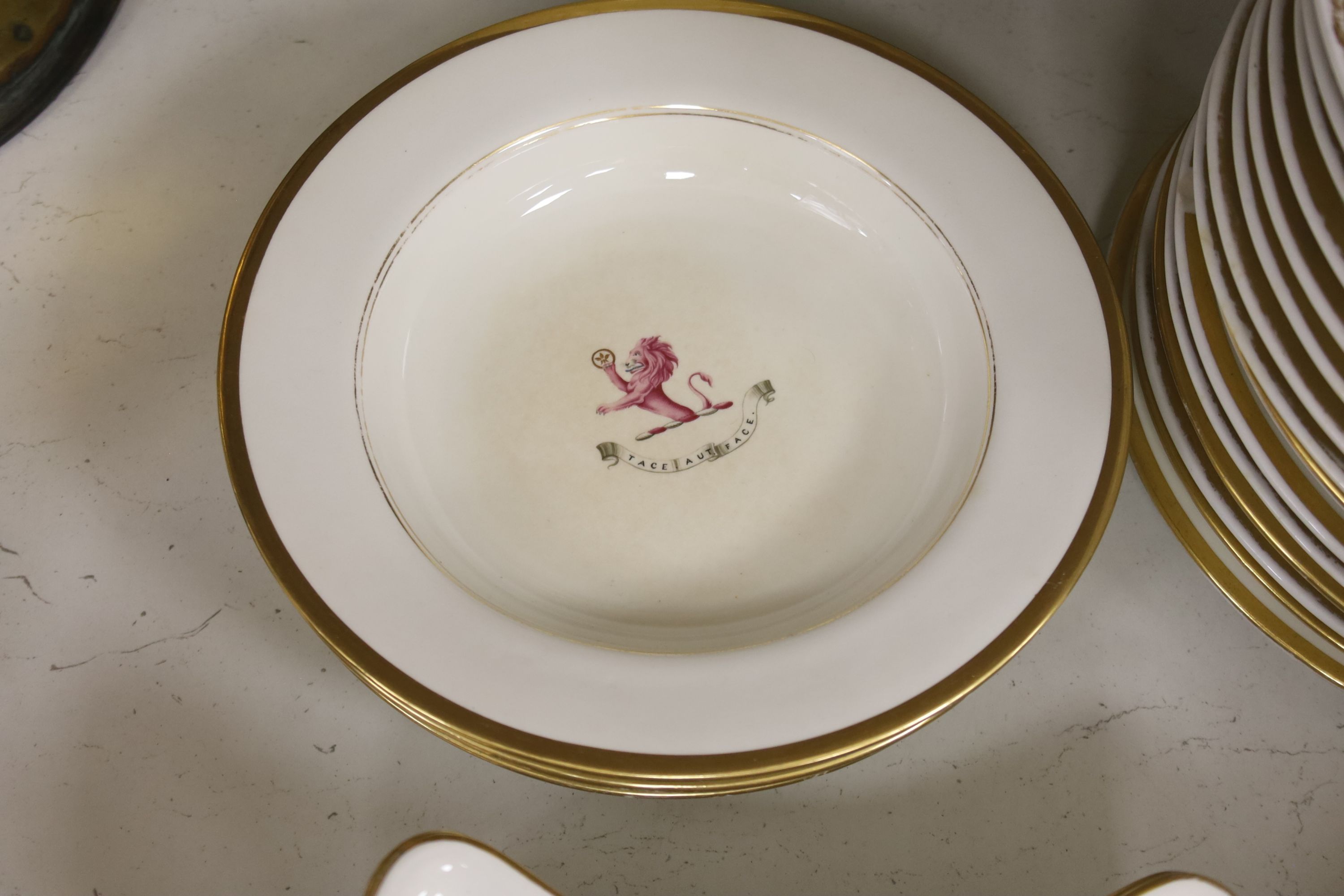 An early 19th century crested part dinner service, by Chamberlains Worcester, and another similar service